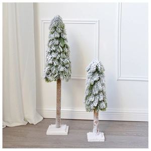 Detail of two mini flocked Christmas trees with snow effect on cedar wood bases