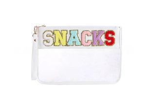 Macro detail of SNACKS chenille patches with golden sequins on a white cosmetic bag