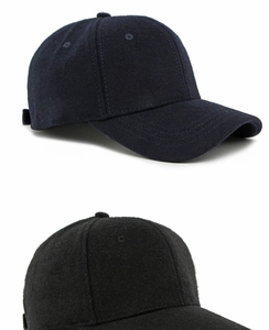 Detailed texture of navy and black wool baseball caps with six-panel construction
