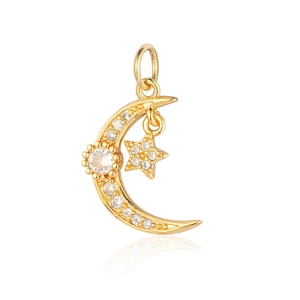 Macro detail of gold moon and star pendant with cubic zirconia inlay on white background