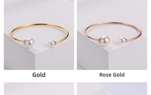 Detail view of gold and rose gold open pearl bangles with double pearl accents
