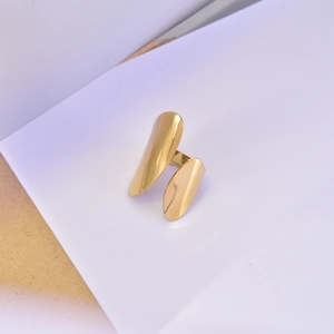 Detail of 18K gold-plated open ring with abstract leaf shapes and mirror-polished finish