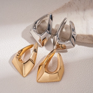 Irregular geometric earrings with 18K gold and silver plating on textured stone base