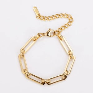 Detailed macro view of golden stainless steel chain link bracelet with lobster clasp