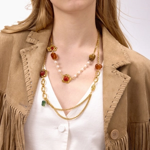 Detail of layered gold resin necklace with floral charms and multi-colored beads