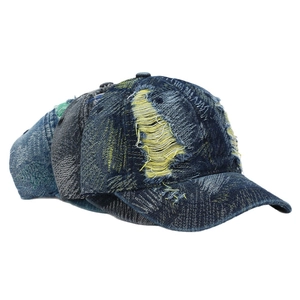 Vintage distressed washed denim baseball cap with yellow frayed holes in dark blue denim