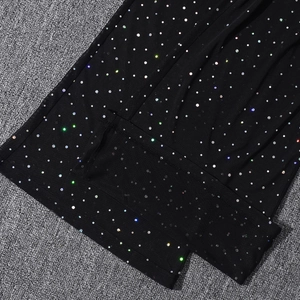Detailed macro view of black mesh fabric featuring sparkling colorful rhinestones