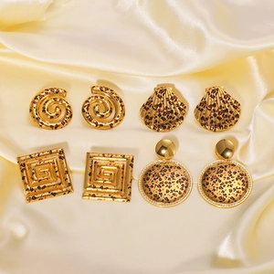 Vintage gold-plated animal print earrings set with leopard pattern on silk background
