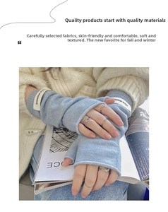 Close-up of light blue knitted fingerless gloves with nice moment decorative tag