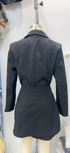 Detail view of the back design on the black office suit set with blazer and skirt