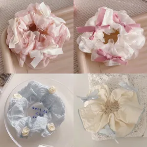 Chiffon bow scrunchies set in pastel colors featuring lace and ribbon details