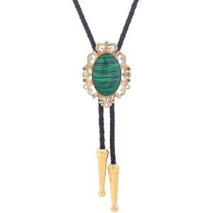 Detail of vintage gold bolo tie with green malachite stone and black braided leather cord