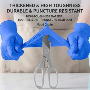 Puncture-resistant blue nitrile food grade gloves undergoing sharp scissor stress test