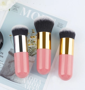 Detailed view of makeup brushes with pink handles and black-and-white gradient bristles