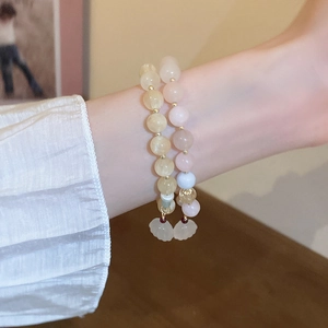 Elegant natural stone stretch bracelets with flower charms and round beads on wrist