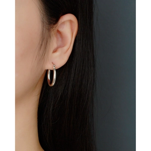 Close-up of minimalist 925 sterling silver hoop earrings with smooth polished finish