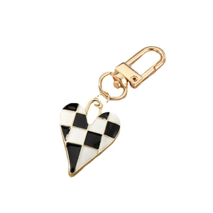 Chic heart-shaped keychain with black and white checkerboard pattern and gold hardware