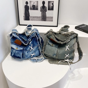 Retro washed denim tote bags with frayed edges and lace-up details in blue and grey-green