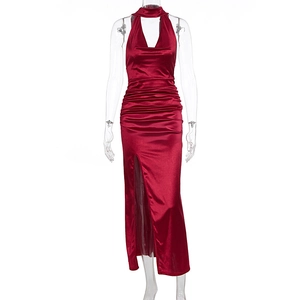 Detail of burgundy satin halter dress with ruched bodice and thigh-high side slit