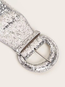 Close-up of a silver sequin wide elastic belt featuring a round metallic buckle detail