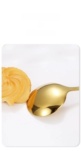 Close-up of golden stainless steel round spoon with mirror polished finish detail