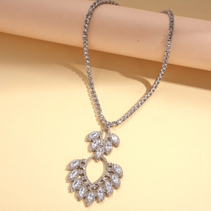 Detailed view of silver necklace featuring hollow teardrop pendant and zircon inlay