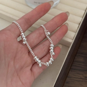 Minimalist 925 sterling silver beaded bracelet with high-polish finish on hand