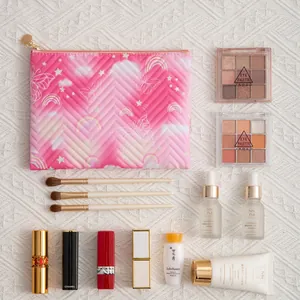 Pink quilted travel makeup bag with cute butterfly pattern and golden zipper closure