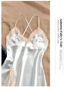 Detail of pearl white satin nightdress with pink lace trim and cross back straps