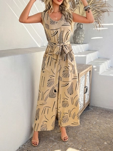 Detail of waist tie and abstract leaf print on sleeveless khaki wide-leg jumpsuit
