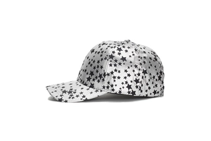 Detail shot of the back of a baseball cap with black star patterns on metallic silver fabric