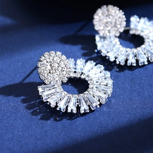 Exaggerated sunburst crystal stud earrings with radiant cubic zirconia in silver finish
