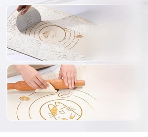 Silicone pastry mat detail with circular measurement scale, scraper, and rolling pin