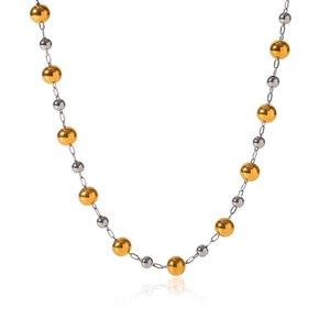 Detail of thin metal chain featuring alternating gold and silver beads with dual-tone shine