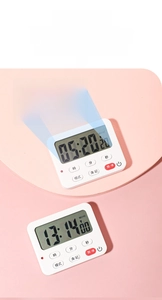 Macro shot of physical buttons and LCD display on magnetic digital kitchen timer