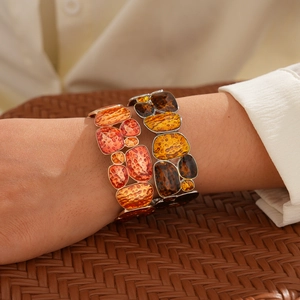 Detailed view of bohemian irregular geometric resin bracelets with metallic frames on wrist