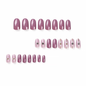 Pink and mauve press-on nails with delicate floral patterns and 3D rhinestone accents