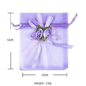 Detail of purple organza gift bag with satin rose decoration and 12x10cm size marking