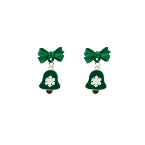 Detail of Christmas earrings featuring green bows and bells with white snowflake patterns