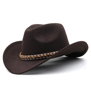 Detail of dark brown wool felt cowboy hat with woven decorative band and bead trim