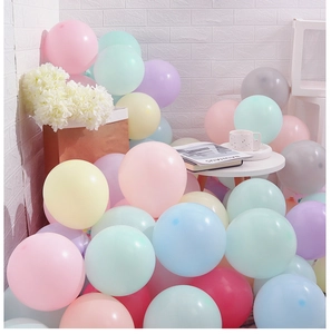 Close-up of pastel macaron latex balloons in pink, blue, and yellow for party decor