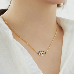 Elegant gold S925 silver Evil Eye necklace with blue zircon pendant worn on model