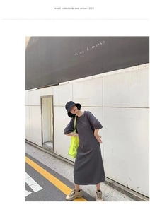 Detail of loose dark grey t-shirt maxi dress with stylish neon yellow crossbody bag