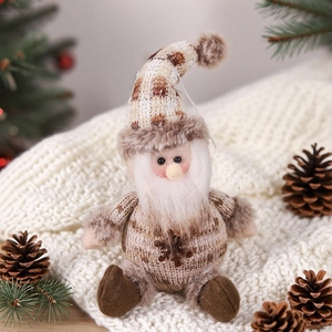 Close-up of a plush Christmas gnome with knitted hat and snowflake sequin detail