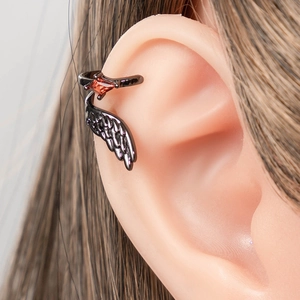 Gothic gunmetal wing ear cuff with red diamond gemstone shown on model's ear