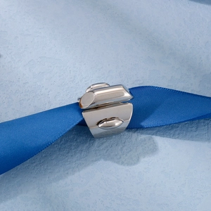 Close-up of a silver titanium steel ring displayed on a dark blue satin ribbon