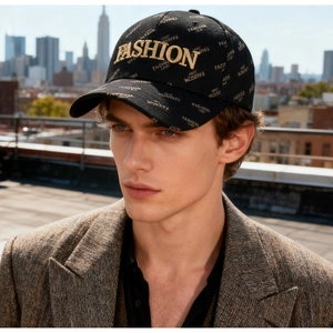Detailed close-up of a black baseball cap with gold embroidery and urban pattern prints