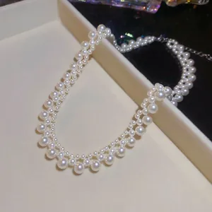 Elegant tiered pearl necklace with adjustable stainless steel chain on a display tray