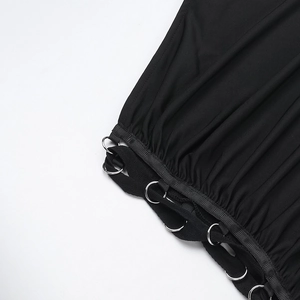Close-up of black fabric texture with silver metal rings and lacing details