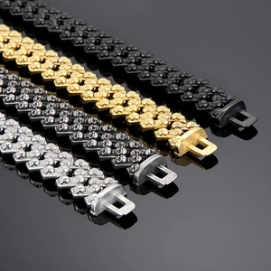 Macro shot of skull-embossed cuban link bracelets in silver, gold, and black finishes